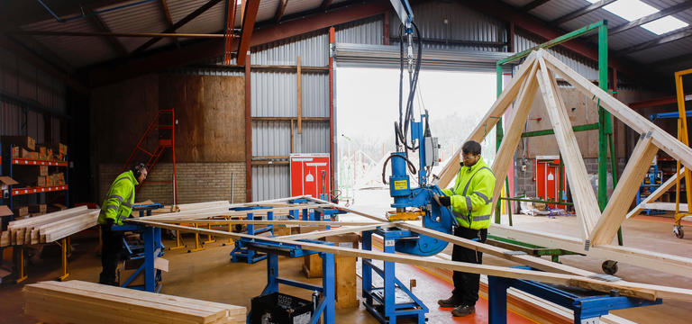 Employees assembling prefabricated frameworks